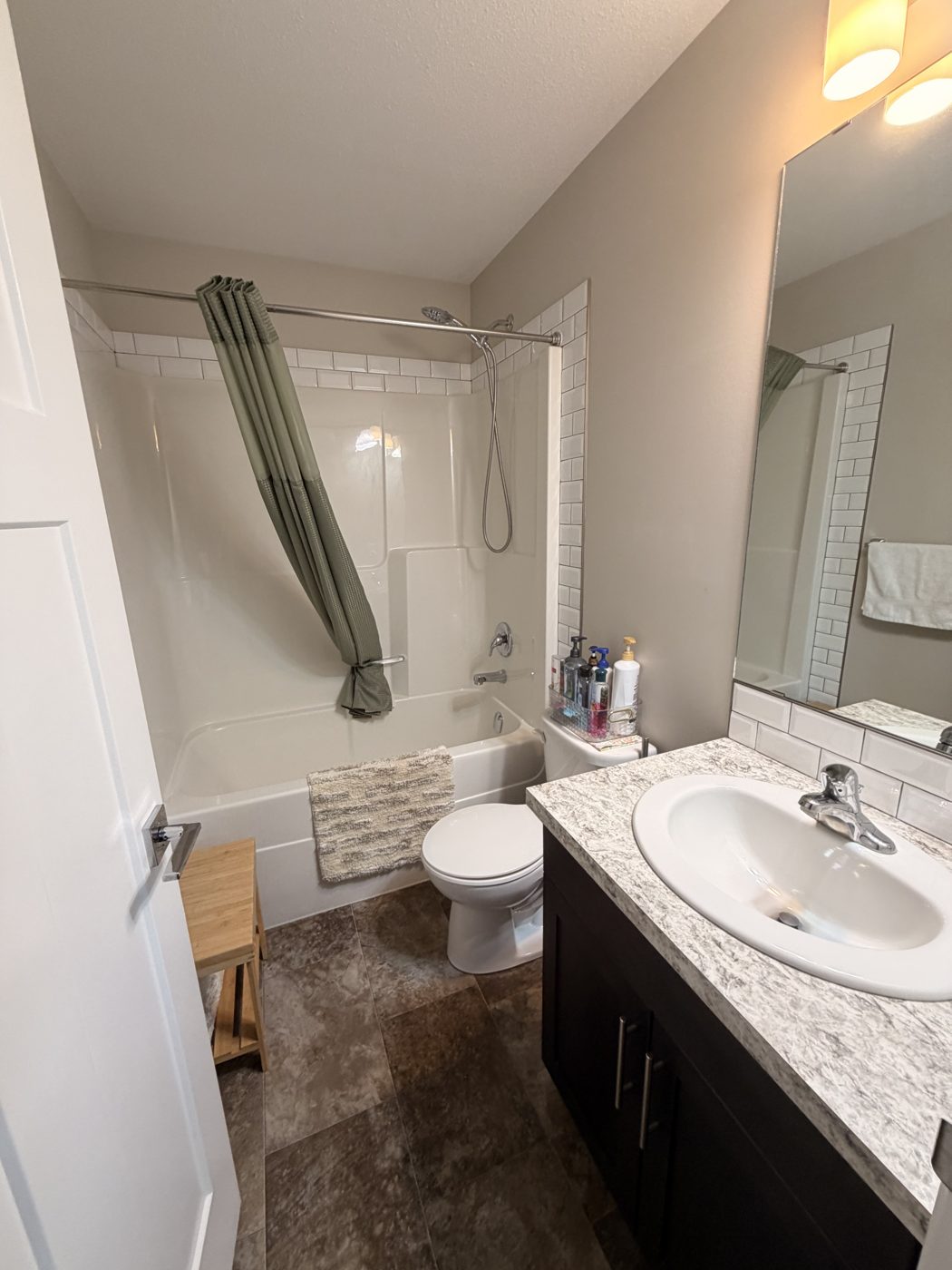 Sparkling clean bathroom with tub, toilet and vanity